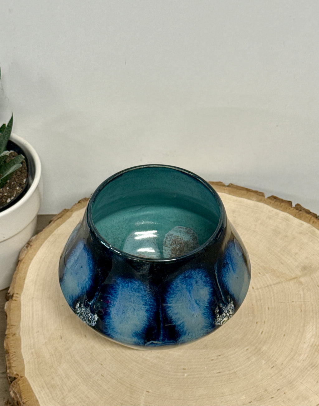 Small black, blue, and white dotted vase