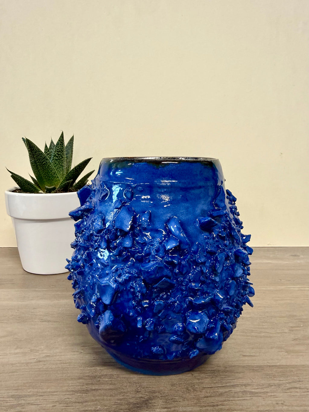 Rocky textured thrown blue vessel