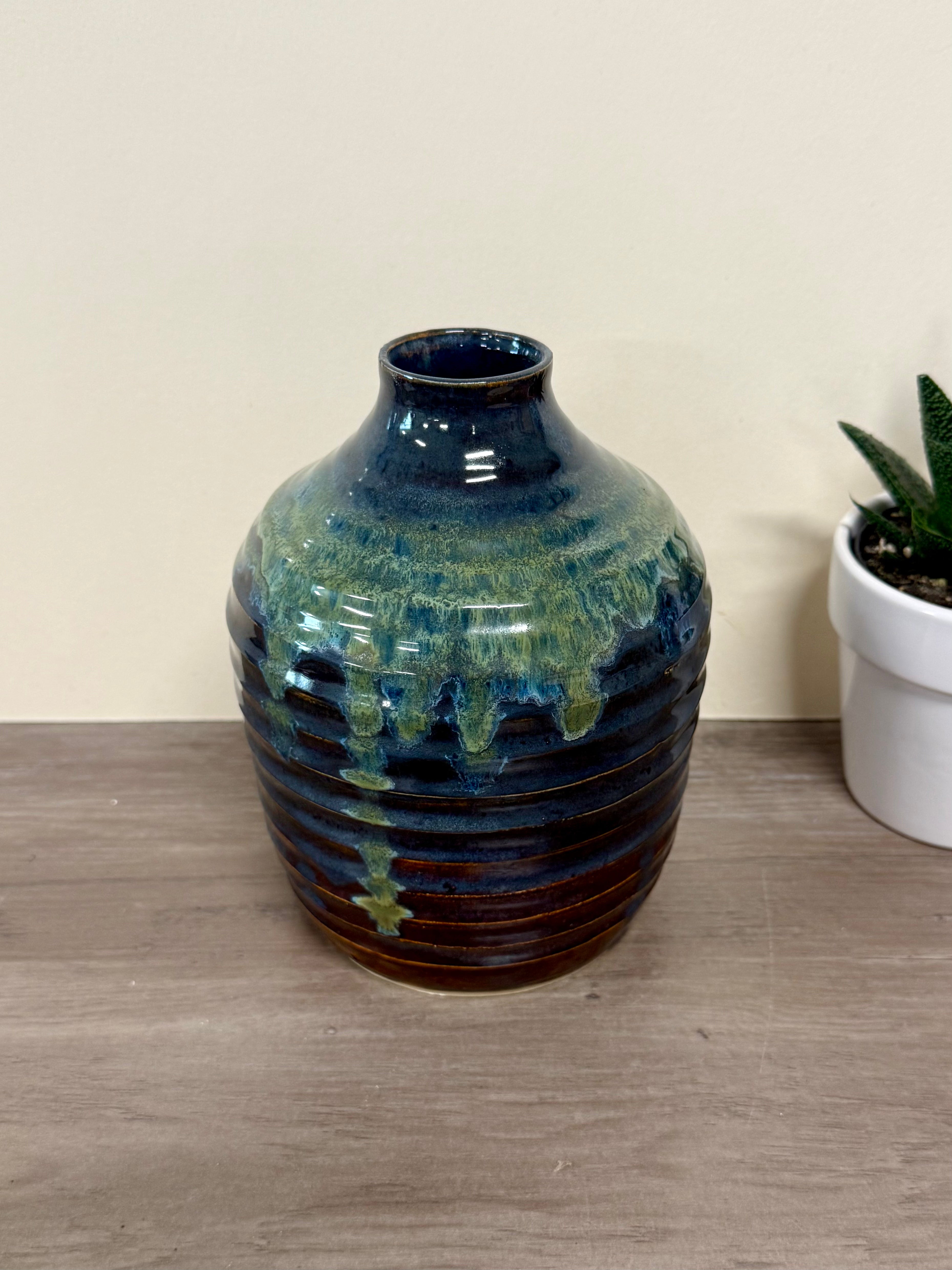 Thrown vase with green, deep blues and red