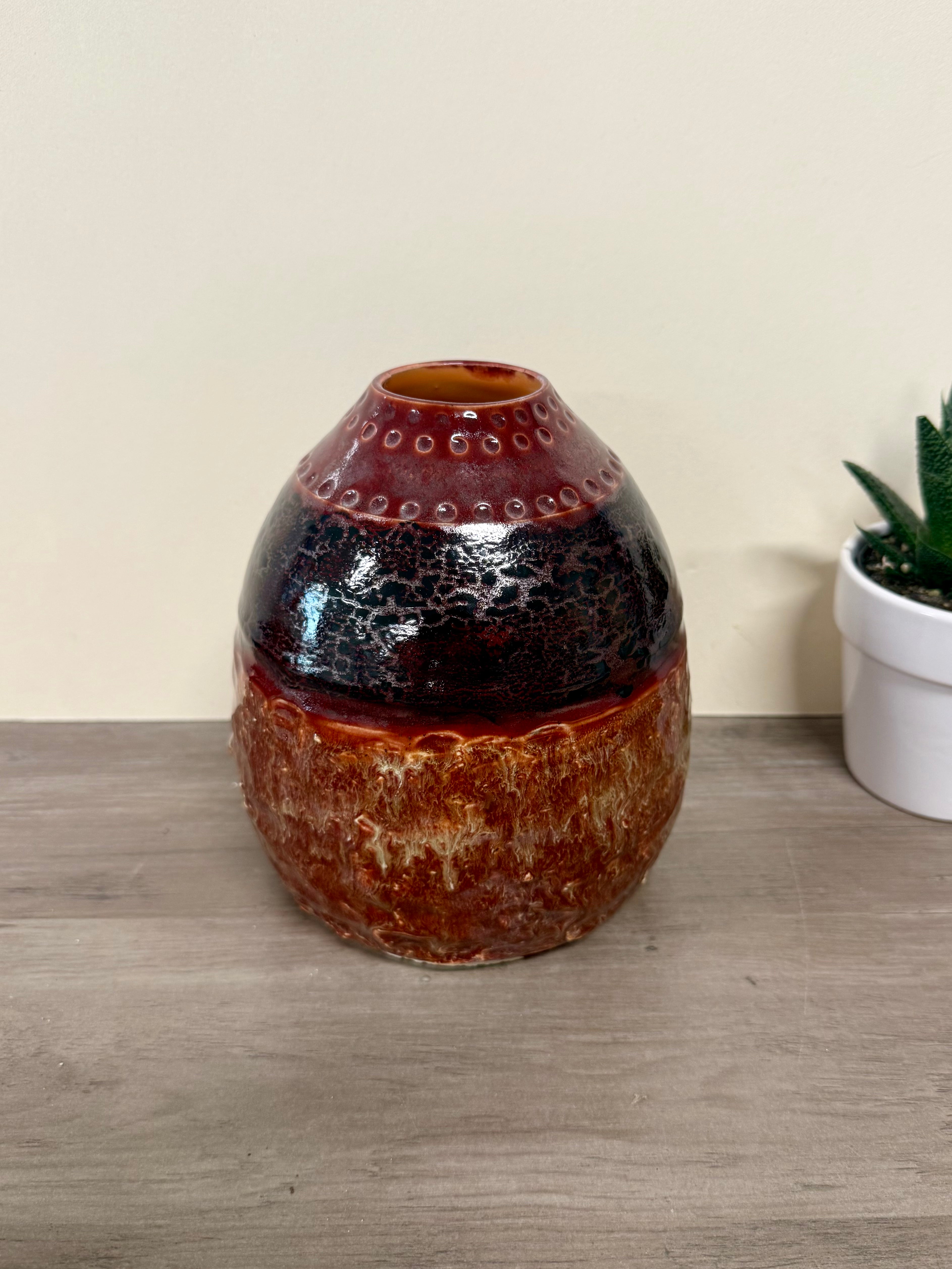 Thrown vase with texture and details, reds and browns