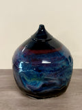 Twisted globe vase with cosmic glaze layers