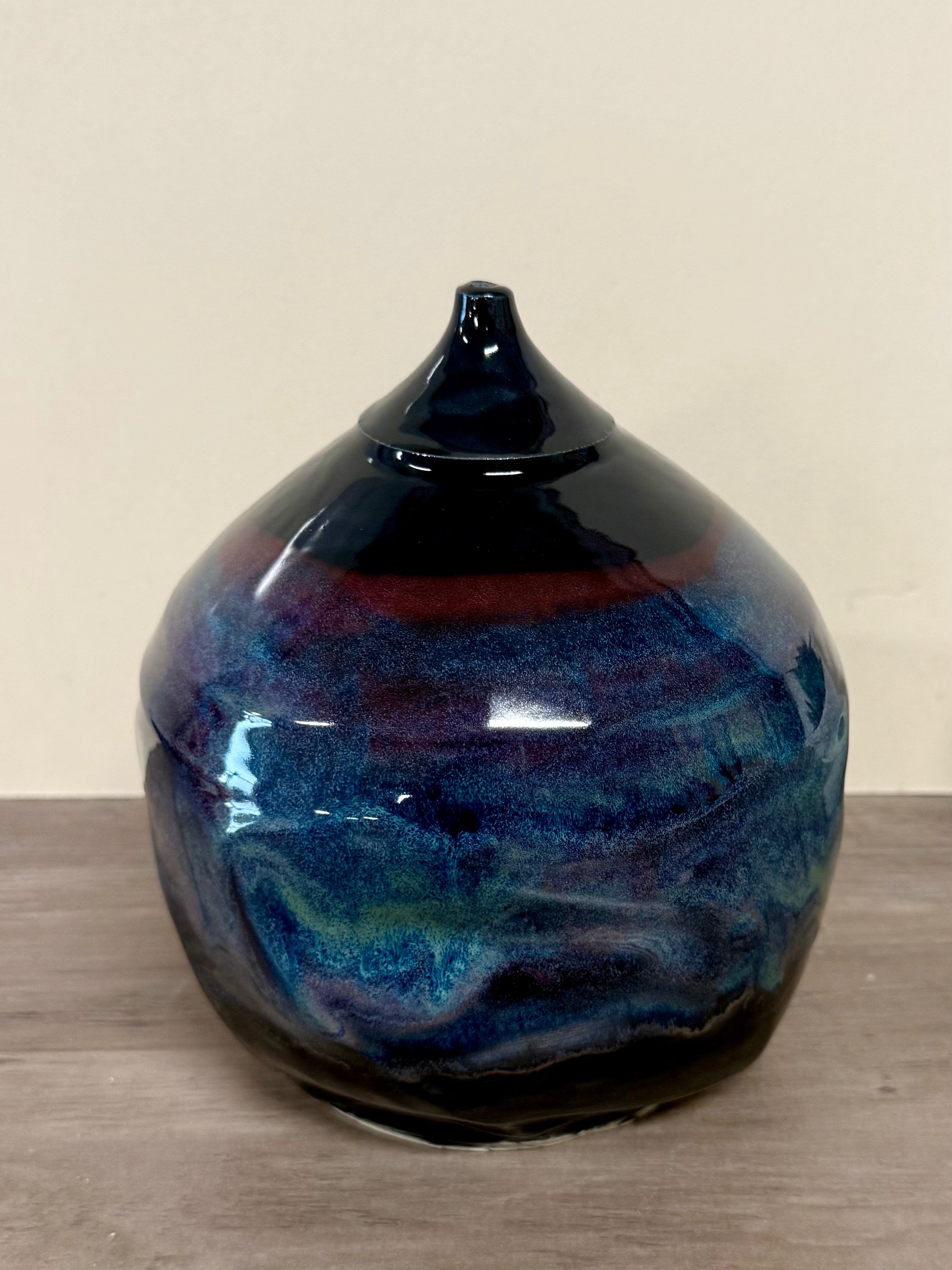 Twisted globe vase with cosmic glaze layers